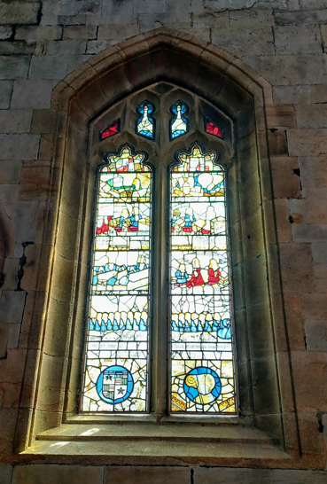 A stained glass window in a stone building